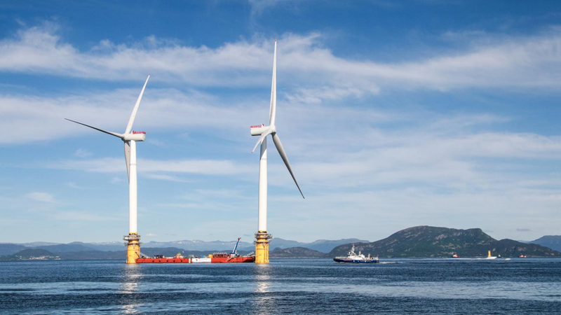 Two floating wind turbines being prepared to sail to Hywind Scotland Pilot Park off the coast of Aberdeenshire (Credit: Terje Aase/ Shutterstock)