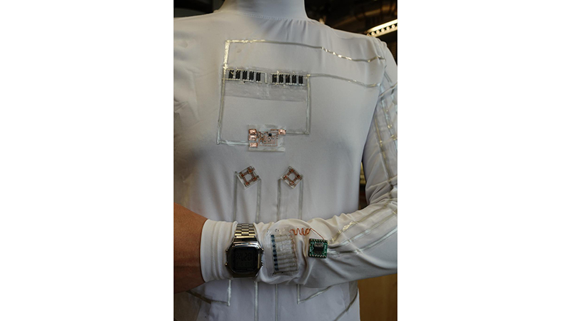 The wearable microgrid uses energy from human sweat and movement to power an LCD wristwatch and electrochromic device (Credit: Lu Yin)
