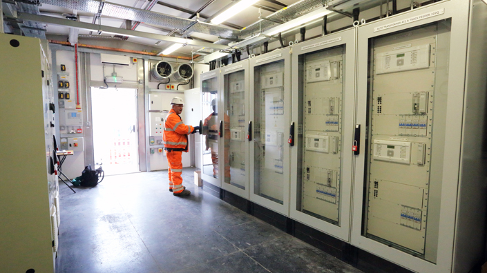 An engineer inspects a Crossrail control room (Credit: Crossrail)