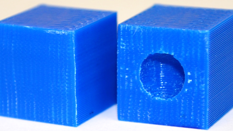 In the block on the right, the embedded sphere prints as a void if the required printing conditions are not used, giving that part lower strength.