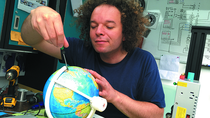 Jude Pullen works on the RadioGlobe, an open-source and 3D-printable model globe that lets users tune into radio stations around the world