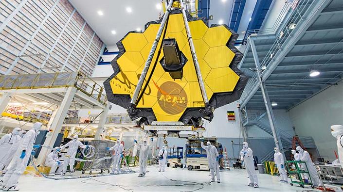 JWST's primary telescope mirror being moved inside a clean room at the Goddard Space Flight Center after completing vibration and acoustic tests. (Credit: NASA/Desiree Stover)