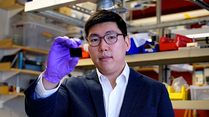 Researcher Jeonyoo Lee with a sample of the material (Credit: MIT)