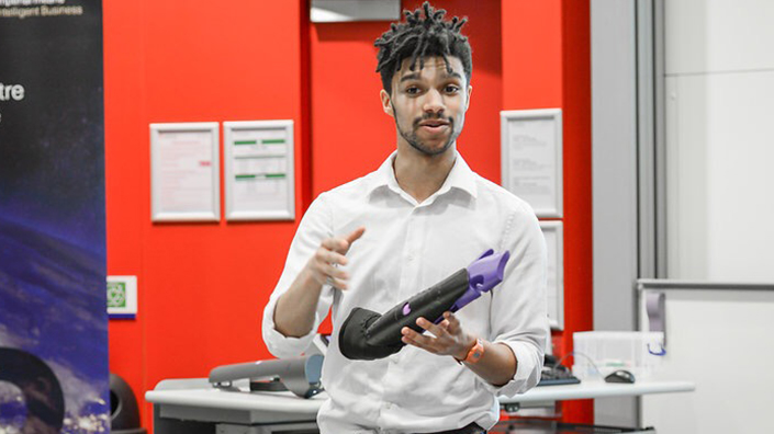 Nate with a Mitt prosthetic. The attachment is designed for carrying objects by hooking onto them (Credit: Mitt)