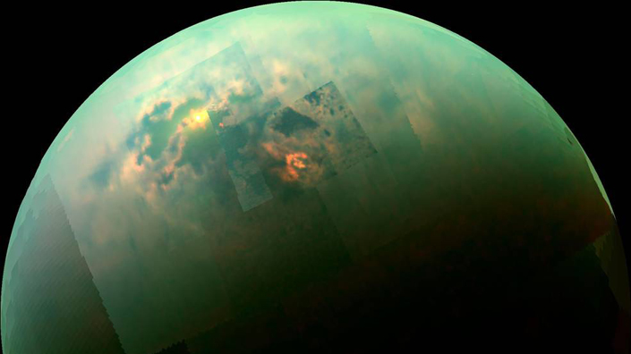 (Sunlight glints off of Titan's northern seas in this near-infrared, colour mosaic from Cassini. Credit: NASA)