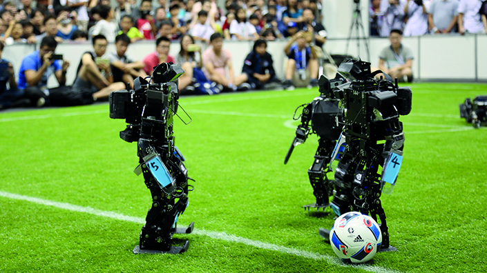 Kid-size humanoid robots try not to fall over (and play football) (Credit: RoboCup)
