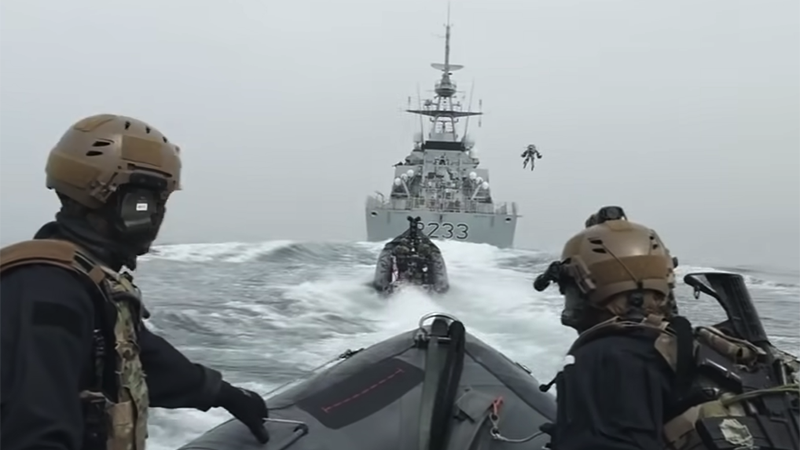 A jet suit pilot flies from an inflatable boat to a larger ship during a Royal Marines exercise with Gravity Industries (Credit for YouTube screenshot: Gravity Industries)