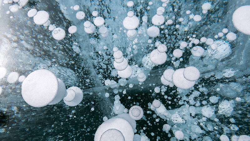 Methane bubbles frozen in ice in the Baikal Lake (Credit: Shutterstock) 