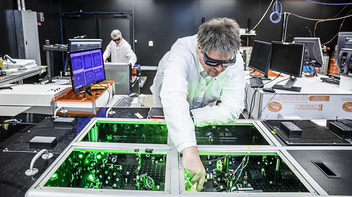Bjorn Manuel Hegelich aligns laser beams in the lab