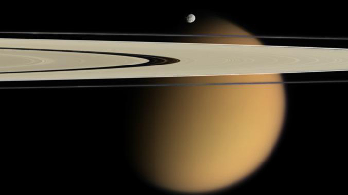 (Cassini's image showing tiny moon Epimetheus and Titan, behind, with Saturn's A and F rings stretching across the picture. Credit: NASA)