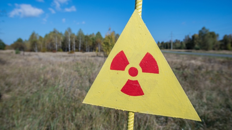 A yellow triangle sign with radiation warning